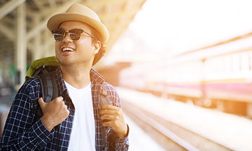 young-man-standing-on-platform-smiling